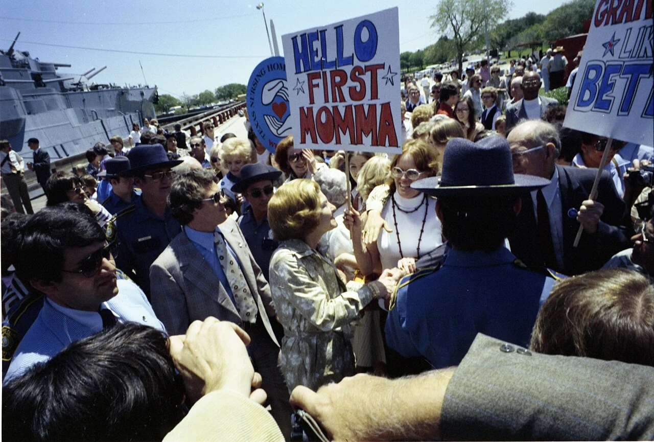 Crowd waving American flags during the 1976 Bicentennial festivities
