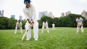 Fielder throwing the ball back to the pitch showing how is cricket played