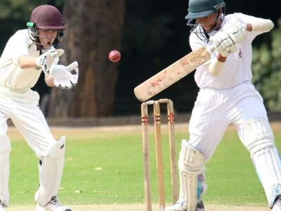 Wicketkeeper catching the ball behind the stumps in how is cricket played