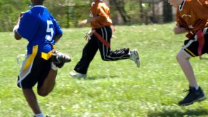 Quarterback preparing to pass the ball following flag football rules.