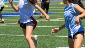 Referee signaling a penalty according to official flag football rules.
