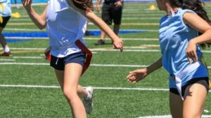 Referee signaling a penalty according to official flag football rules.