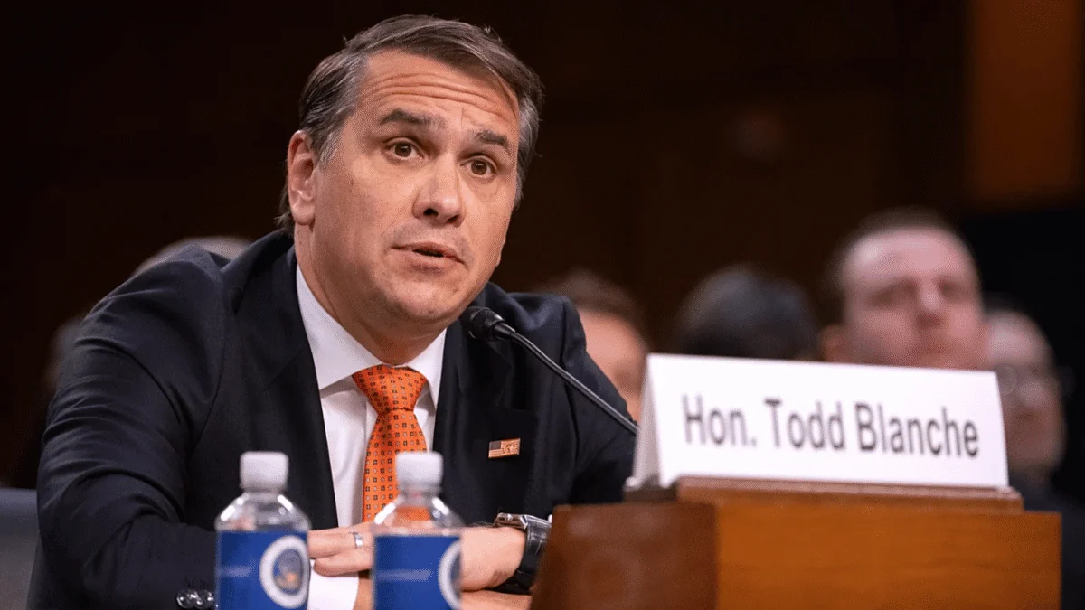 U.S. Attorney General Todd Blanche speaking at a podium during a press briefing.