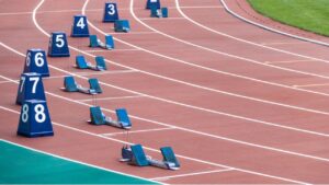 Athletes competing on an oval running track showing what are the events in track and field