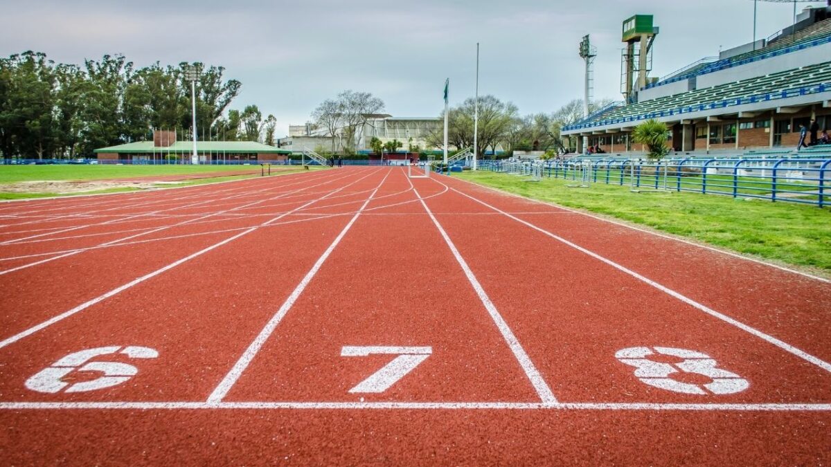 A runner clearing a barrier illustrating what are the events in track and field competitions