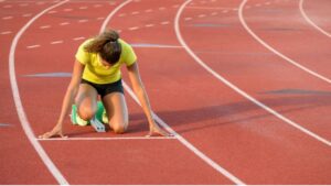 A runner clearing a high hurdle race representing what is Athletics discipline