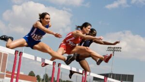 A high jump competitor in mid-air illustrating what is Athletics field event